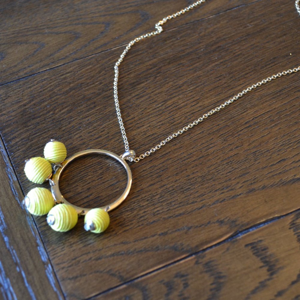 Long gold necklace with gold/yellow pendant